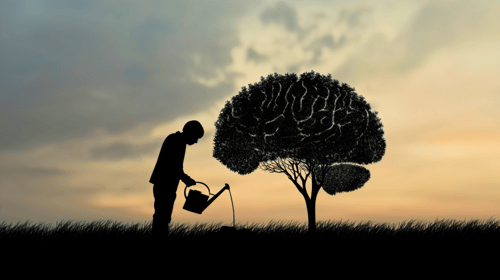 Silhouette of a man watering the tree plant in the shape of the human brain. Blogpost about nurturing an intrapreneurial mindset.